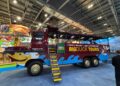 Electric Duck Tours London brown all-electric amphibious vehicle at World Travel Market London, with branding visible on the side.