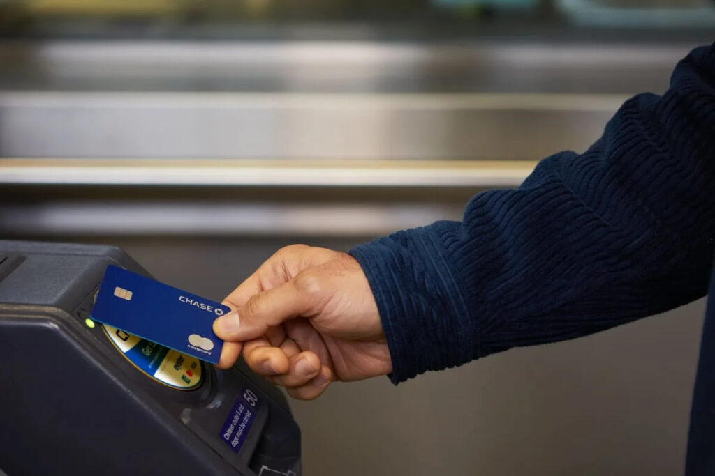London Underground passenger uses Chase debit card to tap in at new TfL ticket barrier for £180 cashback scheme.