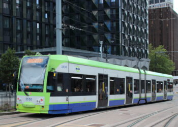 London Tram stopped at East Croydon station with passengers boarding in 2025