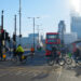 Cyclists pass London Bridge with a red Route 43 bus