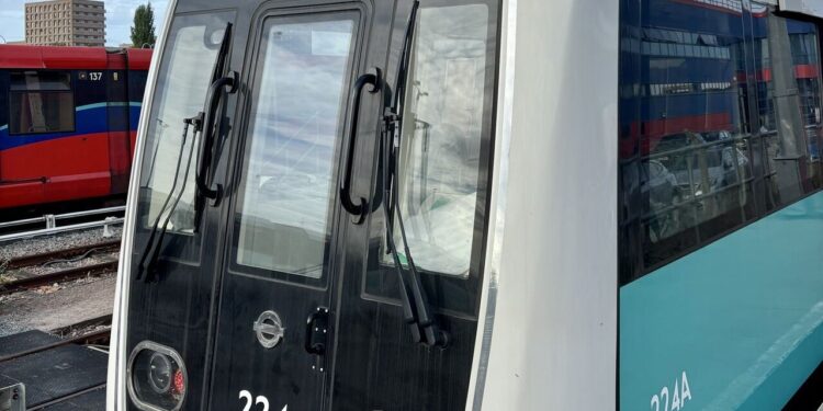 Front view of new DLR train 224 at Beckton depot, showing the modern exterior design.