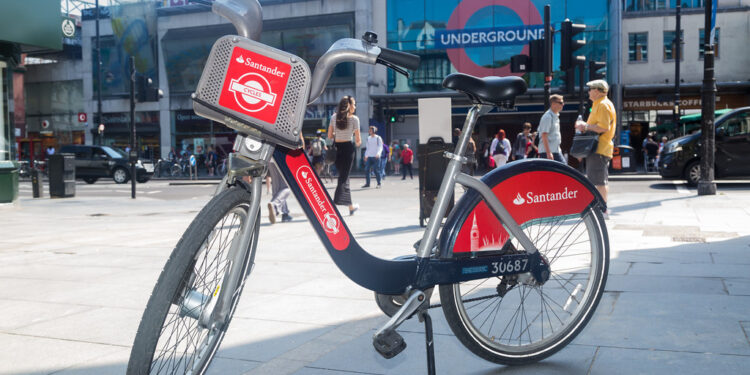 A Santander Cycle parked outside Brixton Underground station on a sunny day