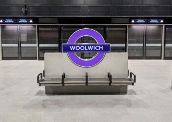 Station interior Woolwich Elizabeth line platform with roundel and platform screen doors