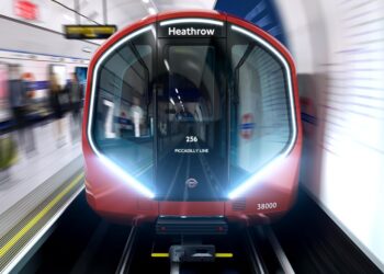 New Piccadilly line train with illuminated front-end lights entering South Kensington station during testing