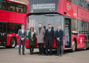 Go-Ahead directors and Transport for London officials standing in front of a red electric double decker bus with a digital display reading "Go-Ahead London's 1000th Zero Emission Bus"