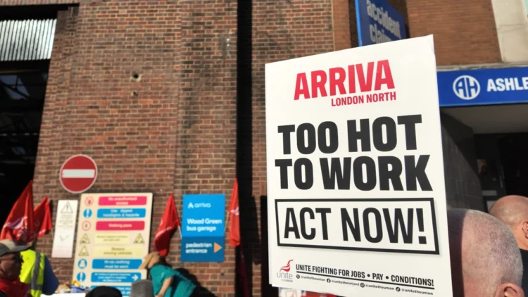 Unite “Too Hot to Work” placard outside Arriva Wood Green bus garage during the August 2026 bus strike.