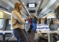 Young passengers travelling together inside a modern train.