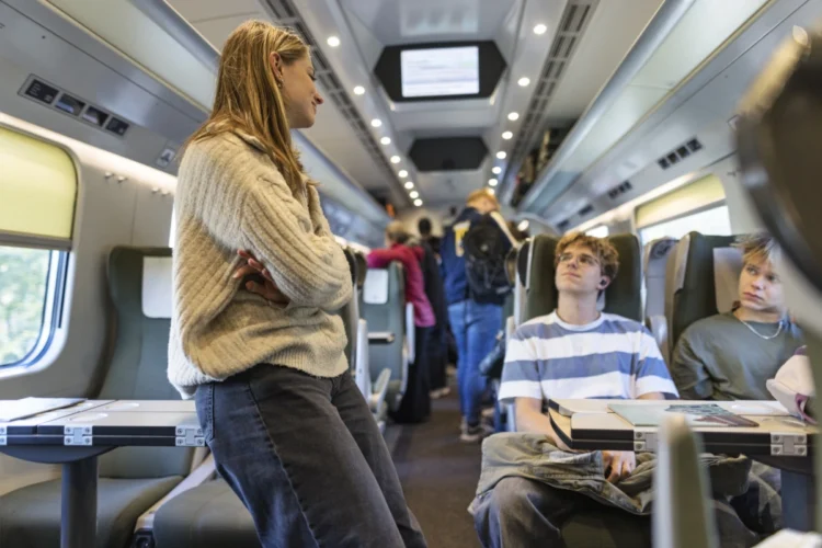 Young passengers travelling together inside a modern train.