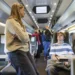 Young passengers travelling together inside a modern train.