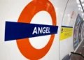 Angel London Underground station roundel displayed on a tiled wall inside the station.