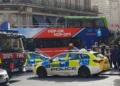 Golden Tours sightseeing bus with police and fire vehicles at the scene of a collision near Trafalgar Square