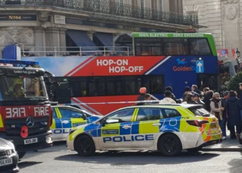 Golden Tours sightseeing bus with police and fire vehicles at the scene of a collision near Trafalgar Square